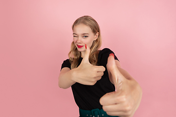 Image showing Young emotional woman on pink studio background. Human emotions, facial expression concept.