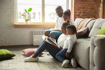 Image showing Young african family during quarantine, insulation spending time together at home