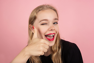 Image showing Young emotional woman on pink studio background. Human emotions, facial expression concept.