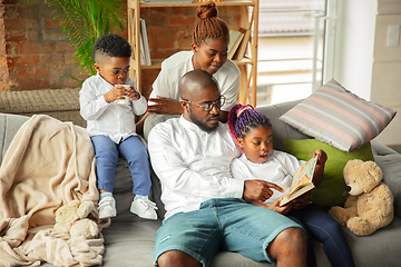 Image showing Young african family during quarantine, insulation spending time together at home