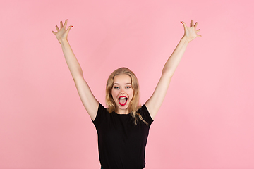 Image showing Young emotional woman on pink studio background. Human emotions, facial expression concept.