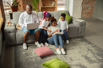 Image showing Young african family during quarantine, insulation spending time together at home