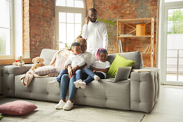 Image showing Young african family during quarantine, insulation spending time together at home