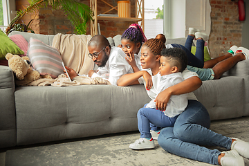 Image showing Young african family during quarantine, insulation spending time together at home