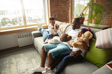 Image showing Young african family during quarantine, insulation spending time together at home