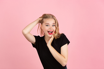 Image showing Young emotional woman on pink studio background. Human emotions, facial expression concept.