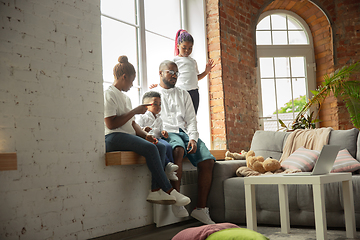 Image showing Young african family during quarantine, insulation spending time together at home