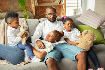 Image showing Young african family during quarantine, insulation spending time together at home