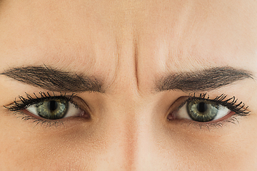 Image showing Close up of face of beautiful caucasian young woman, focus on eyes. Human emotions, facial expression, cosmetology, body and skin care concept.