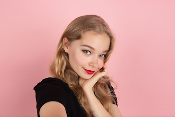 Image showing Young emotional woman on pink studio background. Human emotions, facial expression concept.