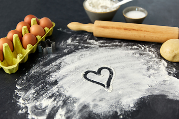 Image showing heart on flour, rolling pin, eggs and dough