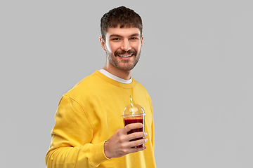 Image showing happy man with tomato juice in takeaway cup