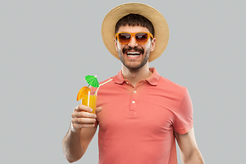 Image showing happy man in straw hat with orange juice cocktail