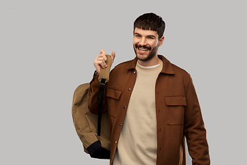 Image showing happy smiling young man with backpack