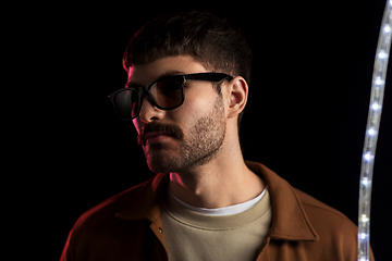 Image showing man in sunglasses over neon lights at nightclub