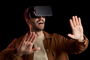 Image showing happy man in vr glasses over black background