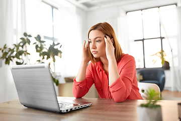 Image showing stressed woman with laptop working at home office