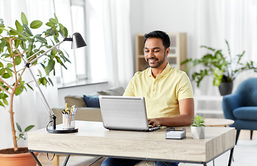 Image showing indian man with laptop working at home office