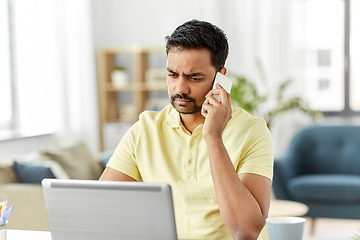 Image showing man calling on smartphone at home office