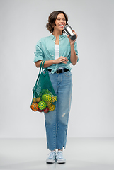Image showing happy smiling woman with food in reusable net bag