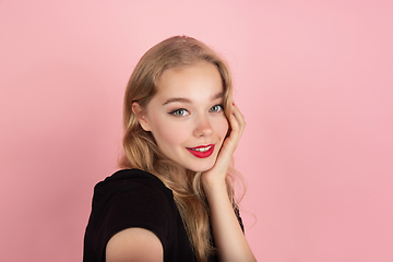 Image showing Young emotional woman on pink studio background. Human emotions, facial expression concept.