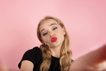 Image showing Young emotional woman on pink studio background. Human emotions, facial expression concept.