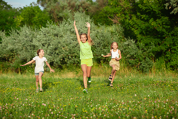 Image showing Kids, children running on meadow in summer\'s sunlight