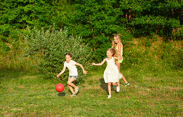 Image showing Kids, children running on meadow in summer\'s sunlight