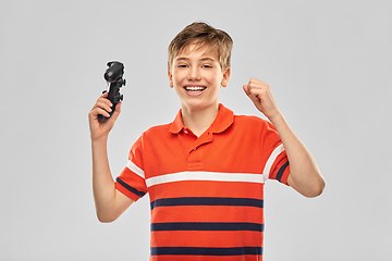 Image showing smiling boy with gamepad playing video game