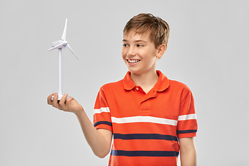 Image showing happy smiling boy holding toy wind turbine