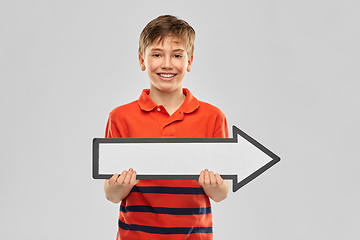 Image showing happy boy holding big white rightwards thick arrow