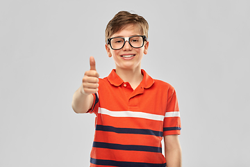 Image showing happy smiling boy in eyeglasses showing thumbs up