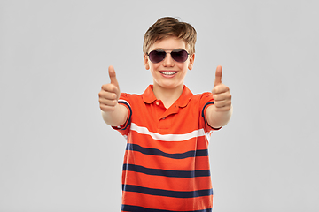 Image showing smiling boy in sunglasses showing thumbs up