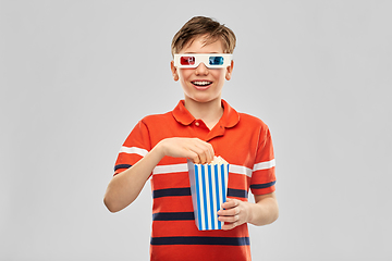 Image showing smiling boy in 3d movie glasses eating popcorn