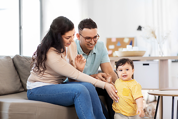 Image showing happy family with child sitting on sofa at home