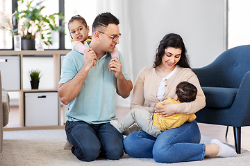 Image showing portrait of happy family sitting on floor at home
