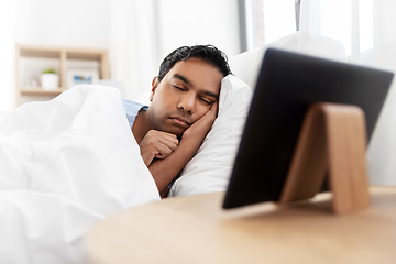 Image showing indian man sleeping in bed and tablet pc at home