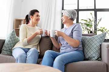 Image showing senior mother and adult daughter drinking coffee