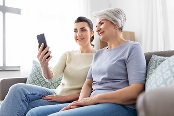 Image showing senior mother with daughter taking selfie at home