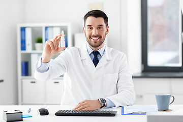 Image showing smiling male doctor with medicine at hospital