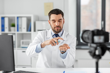 Image showing doctor with hand sanitizer recording video blog