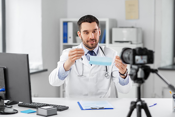 Image showing doctor with mask recording video blog at hospital