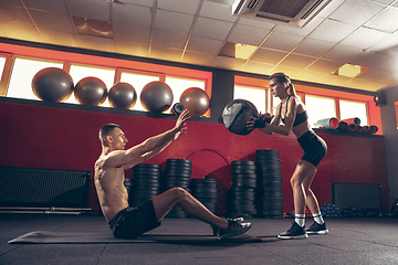 Image showing Beautiful young sporty couple training, workout in gym together