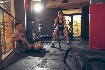 Image showing Beautiful young sporty couple training, workout in gym together