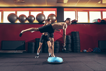 Image showing Beautiful young sporty couple training, workout in gym together