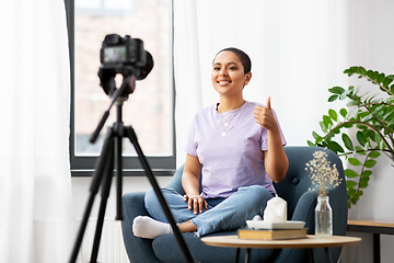 Image showing female blogger with camera video blogging at home