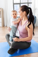 Image showing happy mother with little baby at home