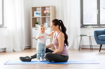 Image showing happy mother with little baby at home