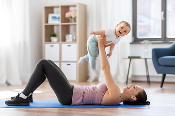 Image showing happy mother with little baby exercising at home
