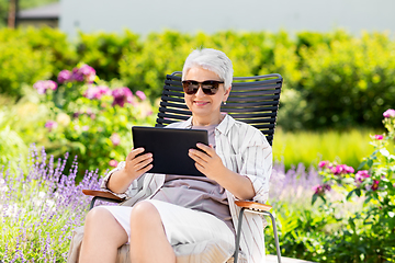 Image showing happy senior woman with tablet pc at summer garden